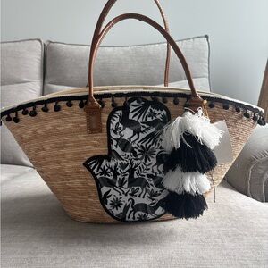 Straw tote with Black Appliqué‎  with Leather Handles and tassel/pom Pom details